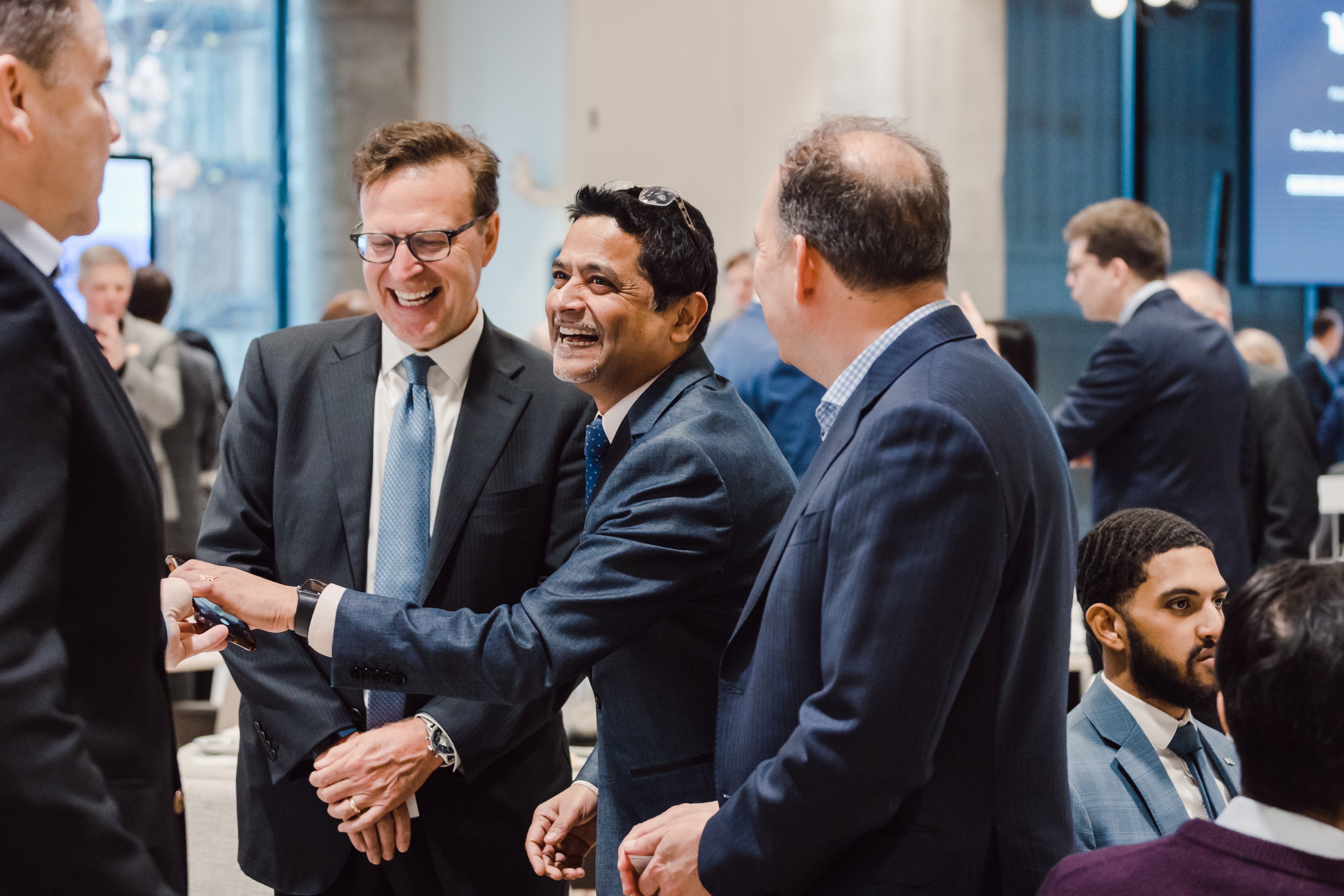 Men shaking hands and laughing