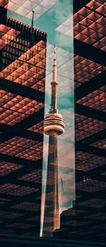 Reflection of the CN tower on a glass building.