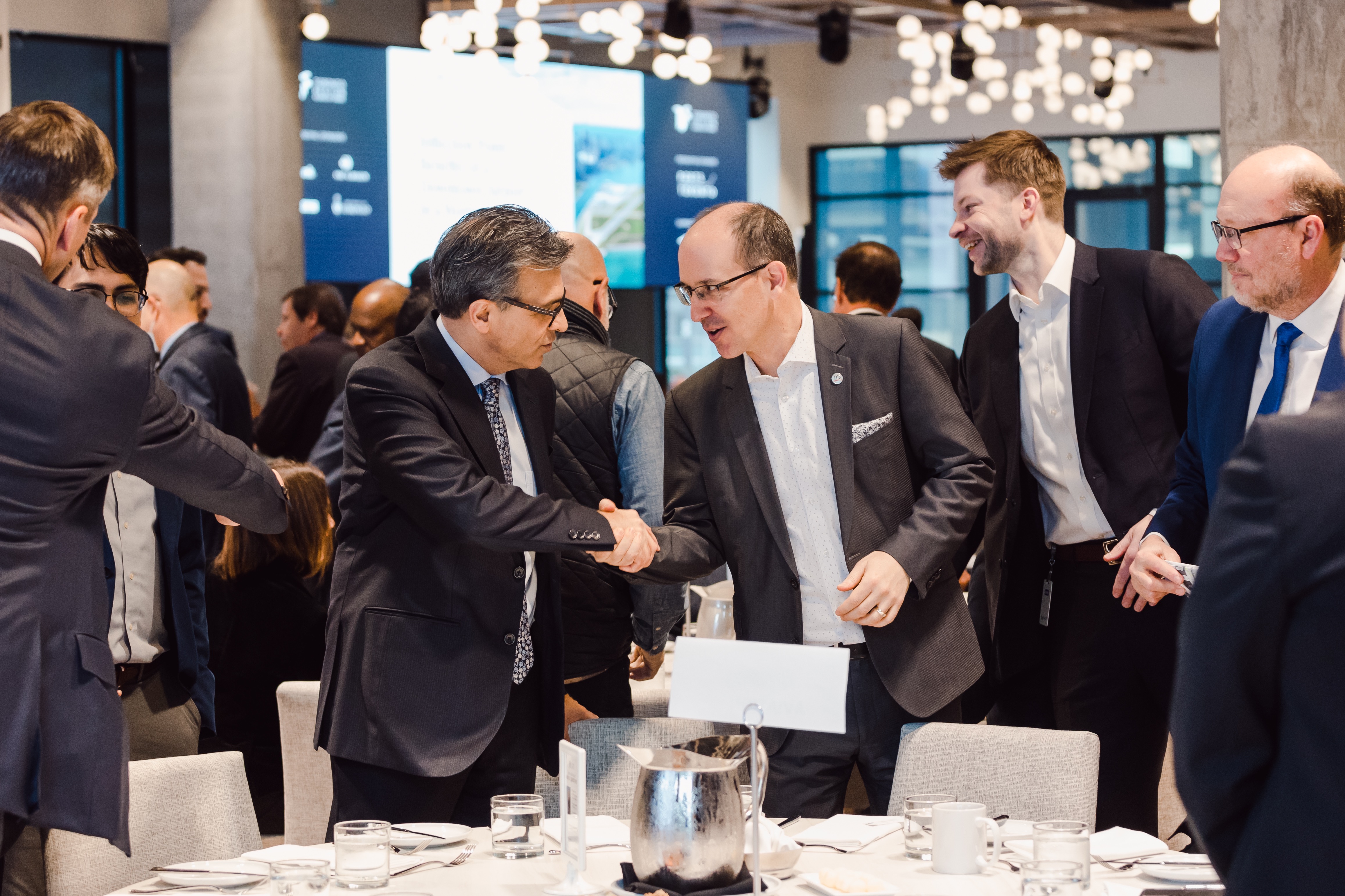 Two men shaking hands at an event