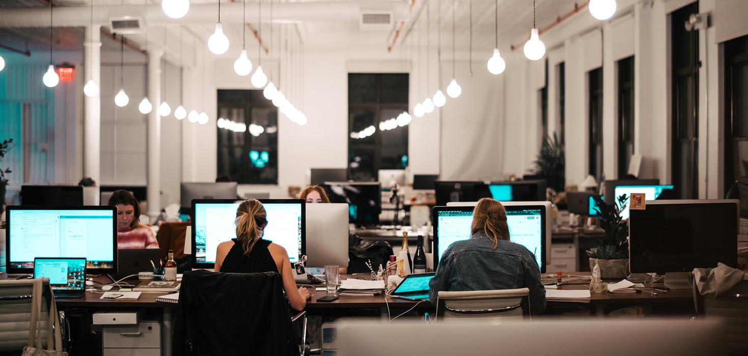 Large room with people at computers