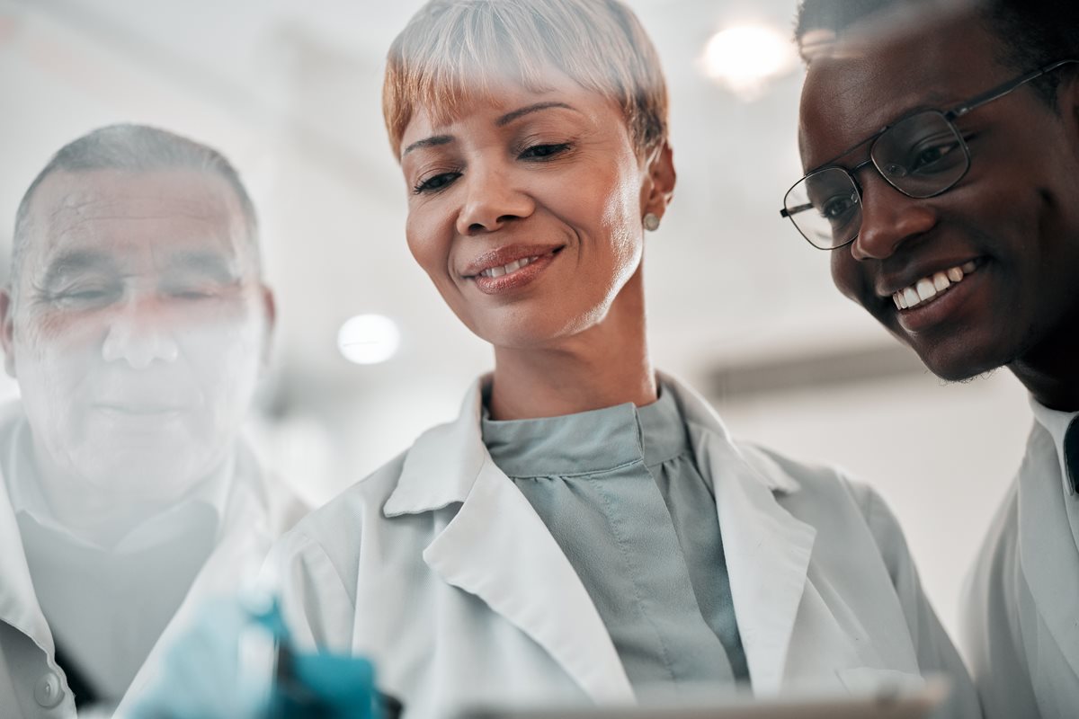 Three doctors looking down at an immunization.