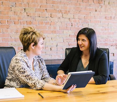 Two women collaborating at work.