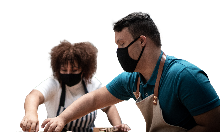 Masked employees working together