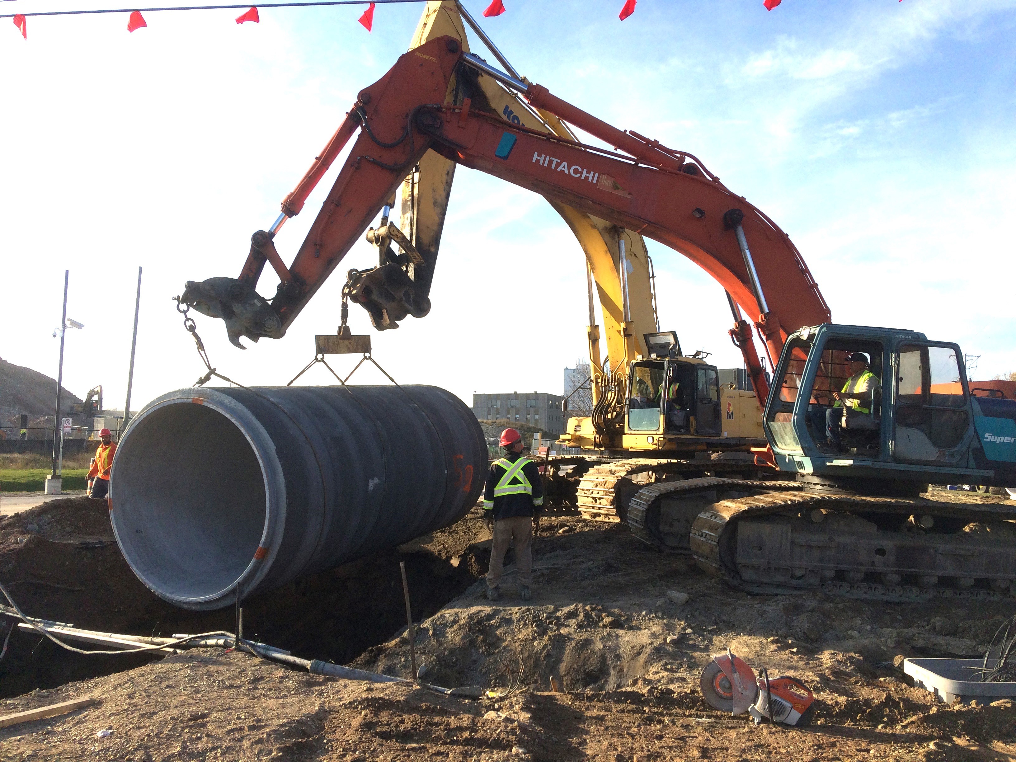 construction workers adding underground pipeline