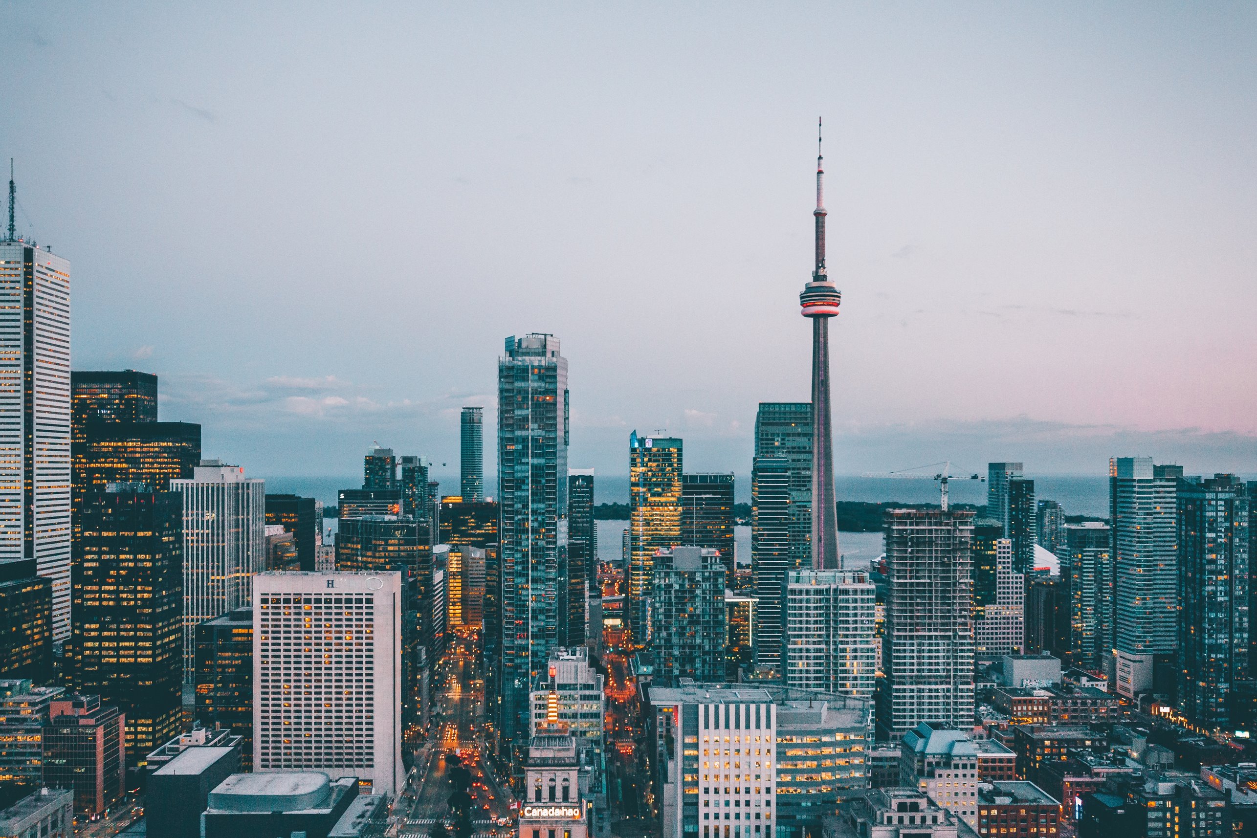 A skyline shot of downtown Toronto against a setting grey sky.