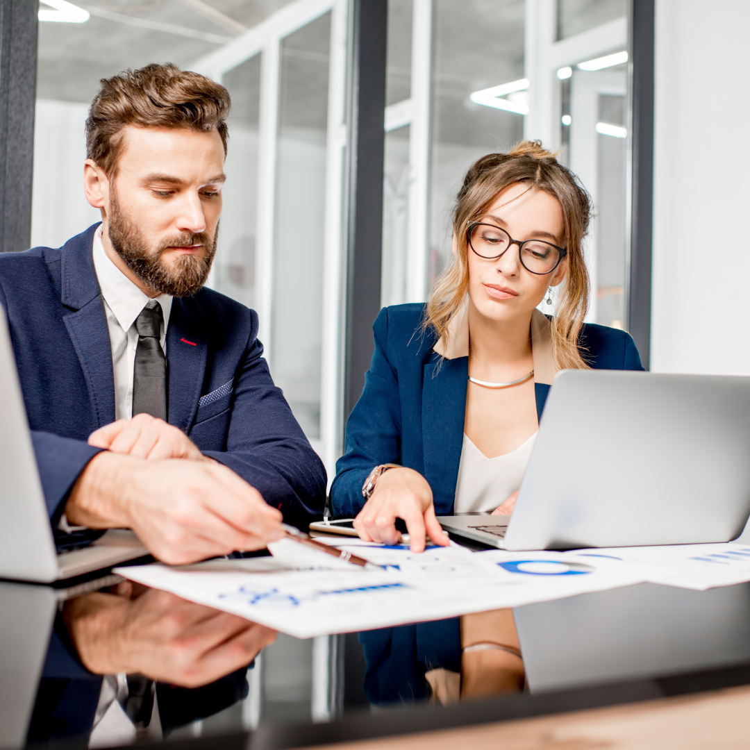 A group of people working together, looking at a presentation.