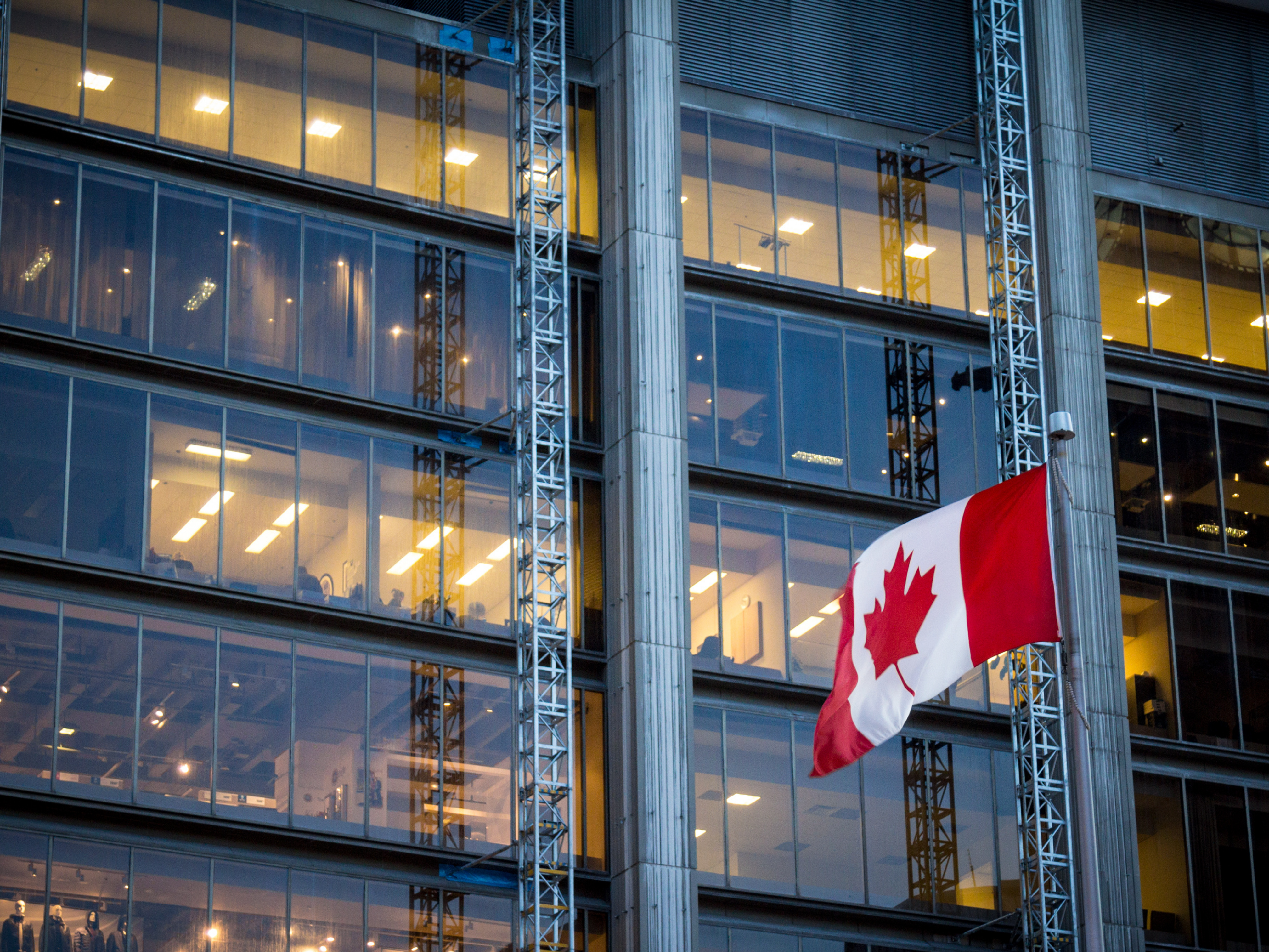 Canadian flag in front of office building