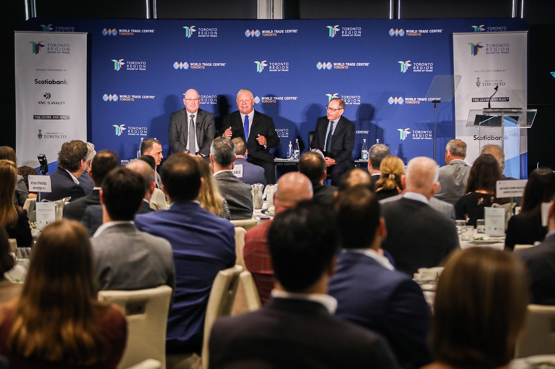 Min Clark, Premier Ford and Giles Gherson sit before a rapt audience at FCP.