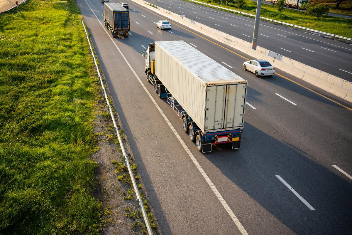 A transport truck moving cargo along a highway.